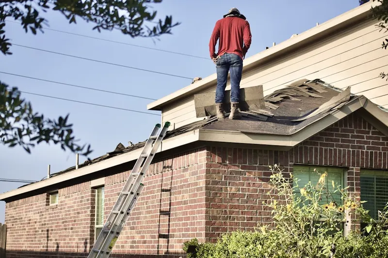 Professional roofer working on a residential roof in Sam Rice Manor